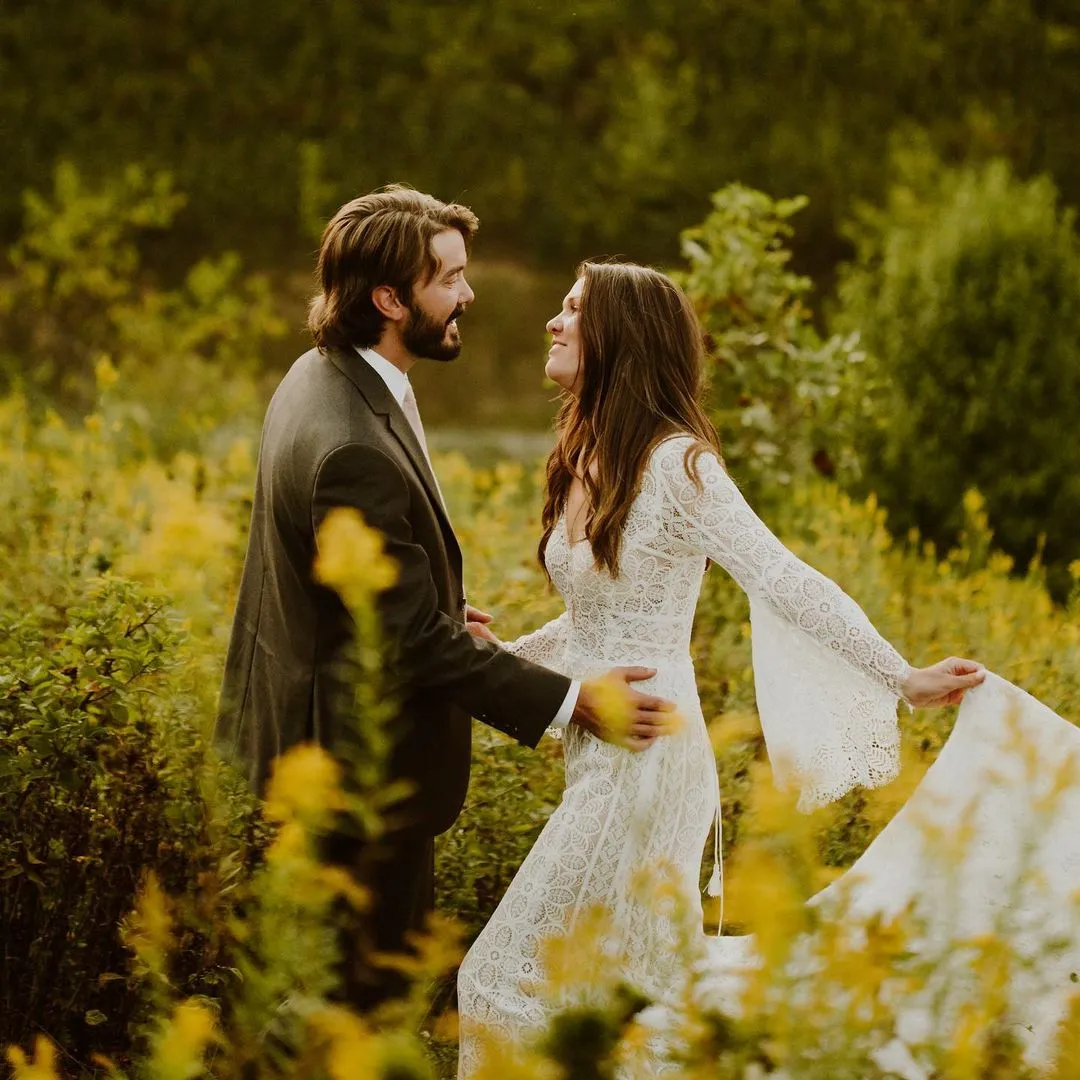 happy couple and flowing wedding dress